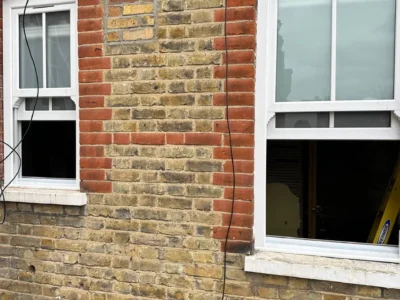 White uPVC sash windows on London yellow-brick house